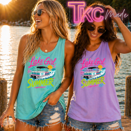 Two women wearing 'Lake Girl Summer' tank tops by a lake.