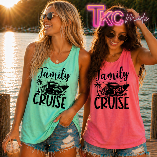 Two women wearing 'Family Cruise 2026' tank tops by a lake.