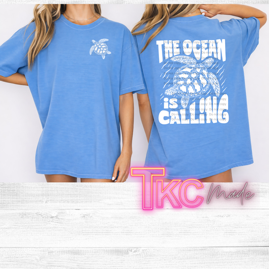 a front and back t shirt. the front featuring a sea turtle and the back says the ocean is calling with a sea turtle