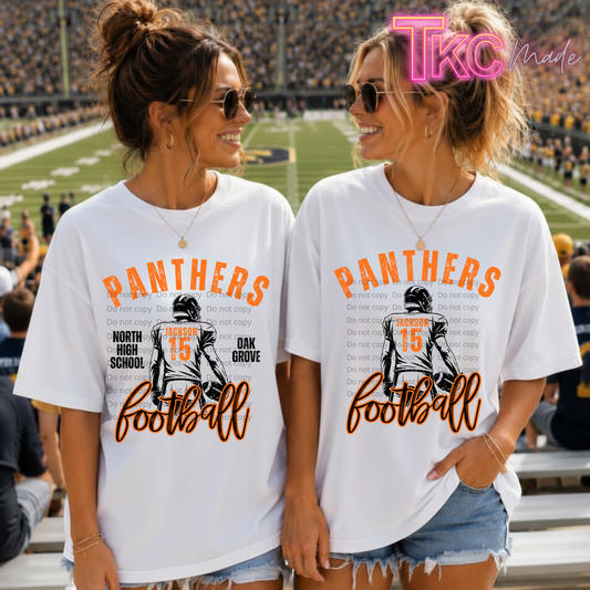 Two women standing in a football stadium wearing matching white graphic t-shirts with orange 'PANTHERS football' text and a black player illustration. A pink 'Tko Made' watermark is visible in the top right corner.