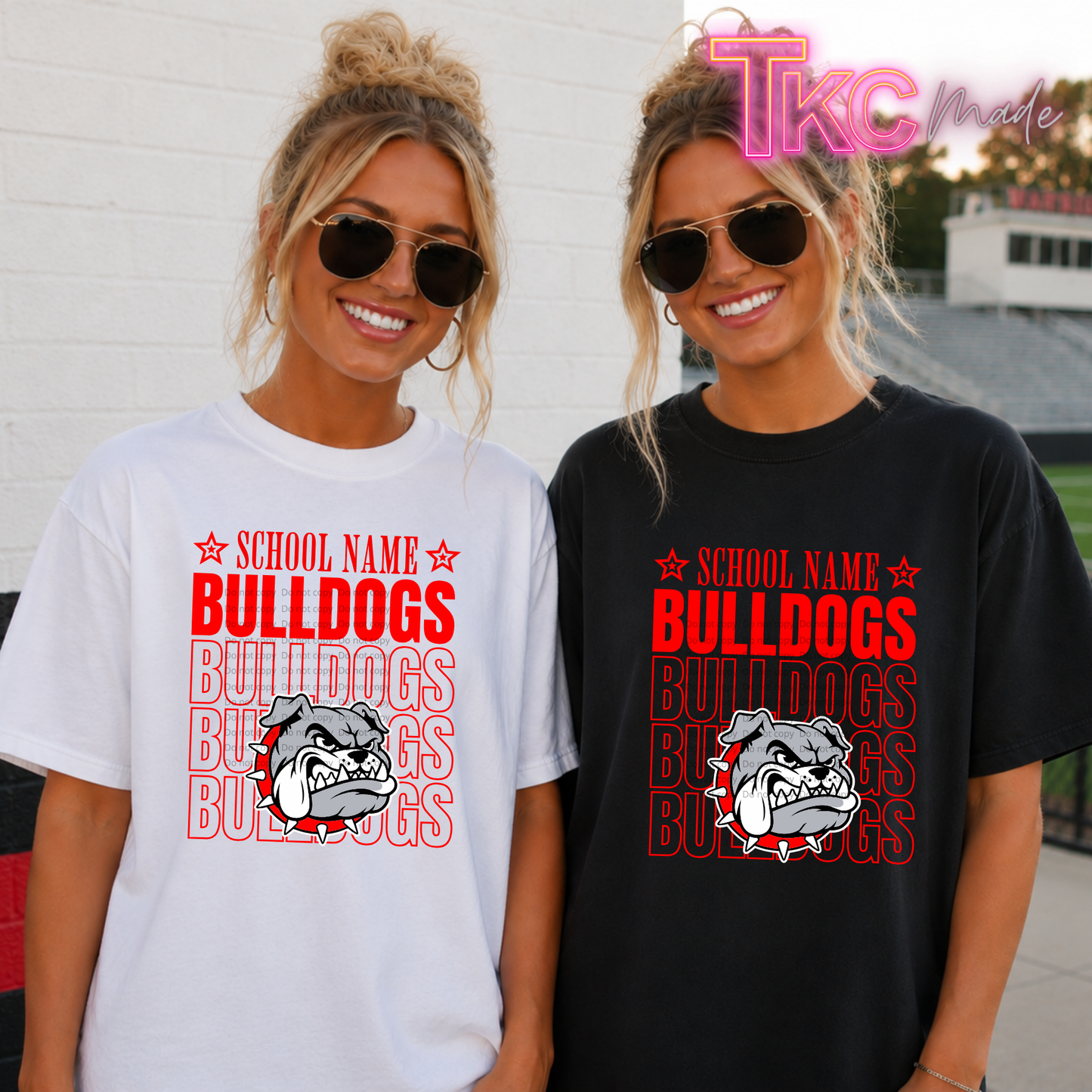 2 girls one in a black shirt one in white with the name Bulldogs repeated on it and a bulldog. At the top it says school name.