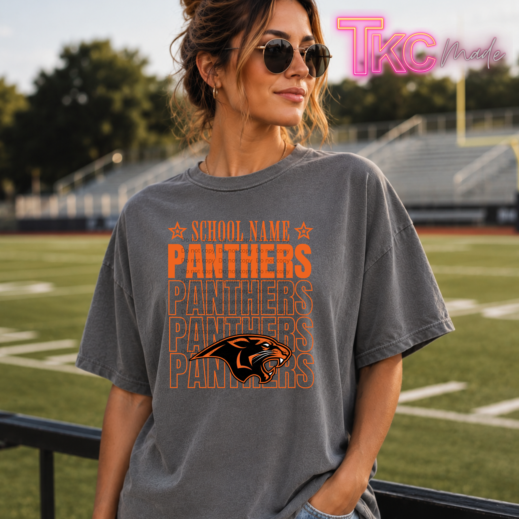 a girl wearing a shirt that says school name and Panthers repeated with a mascot.