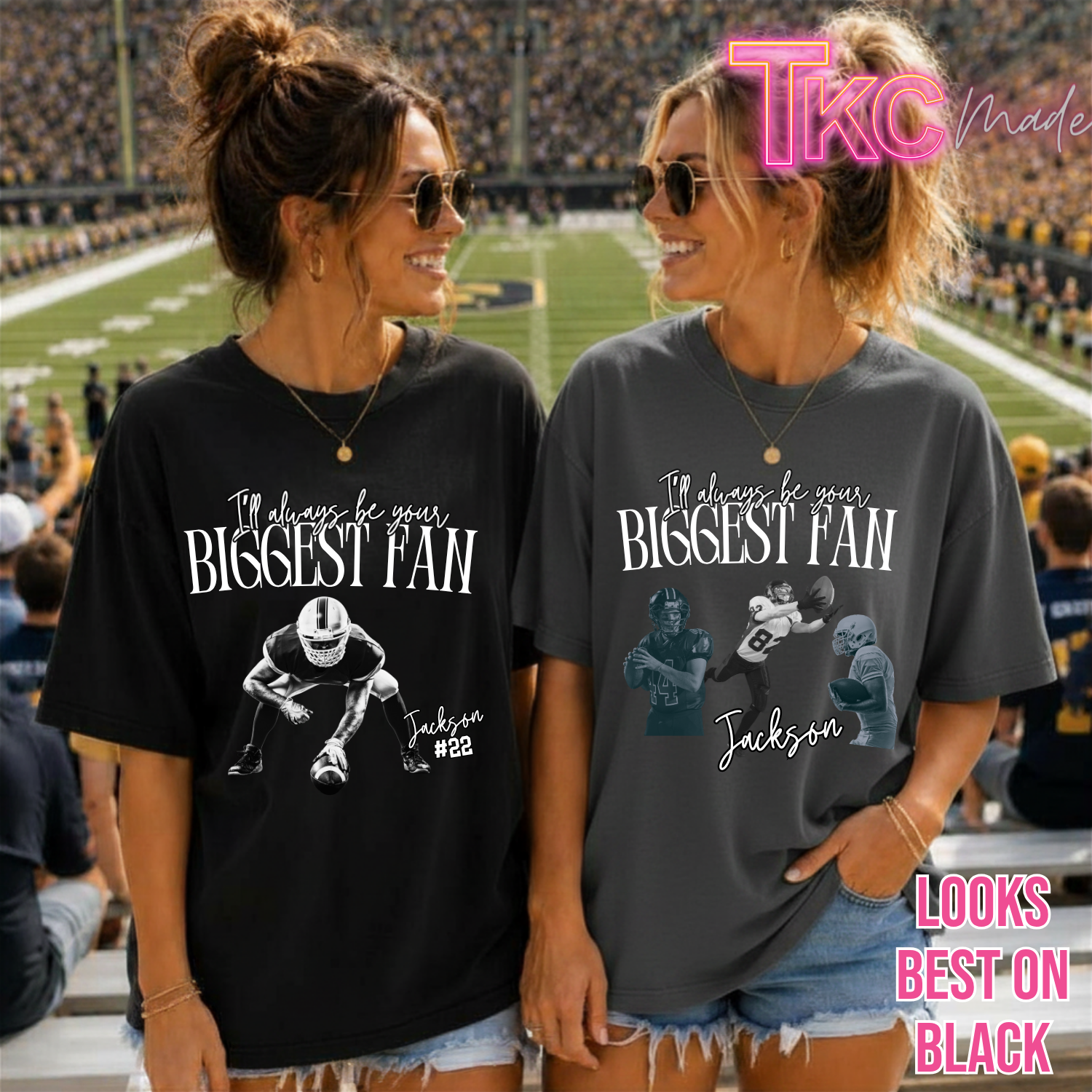 Two women standing in a stadium wearing oversized graphic T-shirts with the text 'I'll always be your BIGGEST FAN' and a football player illustration. One shirt is black and the other is dark gray.